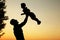 Silhouette of father and son play