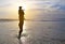 Silhouette father were riding neck carries daughter look out at the sea at sunset