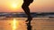 Silhouette feet of young girl dancing at sunset in slow motion