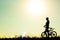 Silhouette of a female cyclist riding Movement on the background