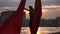 Silhouette of Female dancer showing her flexibility and splits with red aerial silk on the cityscape background during