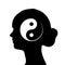 Silhouette of female head with yin yang symbol