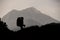 Silhouette of female hiker trekking on mountain