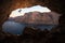 Silhouette of female rock climber on cliff in cave