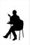A silhouette of a female sitting on a school chair