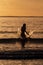 Silhouette of female swimmer having a splash in the Atlantic ocean in Ireland