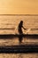 Silhouette of female swimmer having a splash in the Atlantic ocean in Ireland