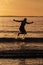 Silhouette of female swimmer having a splash in the Atlantic ocean in Ireland