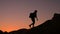 Silhouette of a female tourist who climbs a mountain