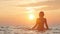 Silhouette figure of a woman coming out from the water in a swimsuit at dawn, a girl swimming in the sea enjoying sunrise, the con