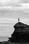 Silhouette of Fijian man stands on a sea cliff in Fiji