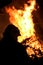 The silhouette of a firefighter putting out a fire