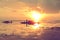 Silhouette fisher man boat in sunrise at lake in Thailand