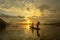 Silhouette fisherman of Bangpra Lake in action when fishing.