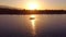 Silhouette of a fisherman enjoying a beautiful sunset in his boat while fishing