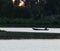 silhouette of a fisherman and fishing boat in the river at dawn