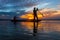 Silhouette fisherman with net at the lake