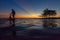 Silhouette fisherman with net at the lake