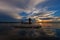 Silhouette fisherman with net at the lake