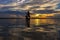 Silhouette fisherman with net at the lake