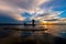 Silhouette fisherman with net at the lake