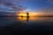 Silhouette fisherman with net at the lake