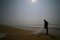 Silhouette of fisherman on the shore of Chandrabhaga beach, india.