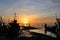 Silhouette fisherman is standing on fishing boat