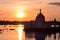 Silhouette of fisherman to drive a boat on the lake