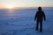 Silhouette of a fisherman walking on the lake