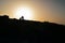 Silhouette of fishermen on a cliff at dusk