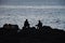 Silhouette of fishermen on rocks, Havana, Cuba