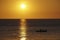 Silhouette fishermen sailed in calm sea at sunset