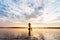 Silhouette of Fishermen throwing net fishing in sunset time at W