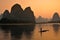 Silhouette of fishermen in Yangshuo, sunset at the LI river. Yangshuo is a popular tourist county and city near Guilin Guangxi
