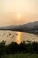 Silhouette of fishing boat, mountain and village