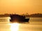 Silhouette of a fishing boat at sunset