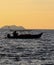 silhouette of a fishing boat at sunset on the ocean