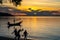 Silhouette fishing boat with unidentified silhouette people