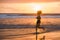 Silhouette of fit and athletic Asian Chinese sporty woman running on beautiful beach doing jogging workout on sunset in fitness he