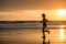 Silhouette of fit and athletic Asian Chinese sporty woman running on beautiful beach doing jogging workout on sunset in fitness he