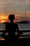 Silhouette of Fitness model doing yoga at sunset time