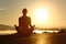 Silhouette of a fitness woman exercising yoga meditation exercises