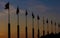 Silhouette of flagpoles at sunset