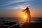 Silhouette of flexible girl with dreadlocks on ocean coast