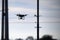 silhouette of a flying drone against the sky and pillars in the city. video shooting from a height