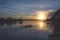 Silhouette of four athlete rowing in coxed four boat at sunrise. Rich blue and orange color. Calm and peaceful atmosphere. Corrib