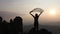 silhouette of free cheering woman hiker open arms at mountain peak, Goals and achievements concept