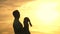 Silhouette. Free father throws up his happy daughter in the sunset sky. Happy family travel. Healthy dad and daughter