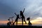 Silhouette freedom biker lovely family at sunset over the ocean.